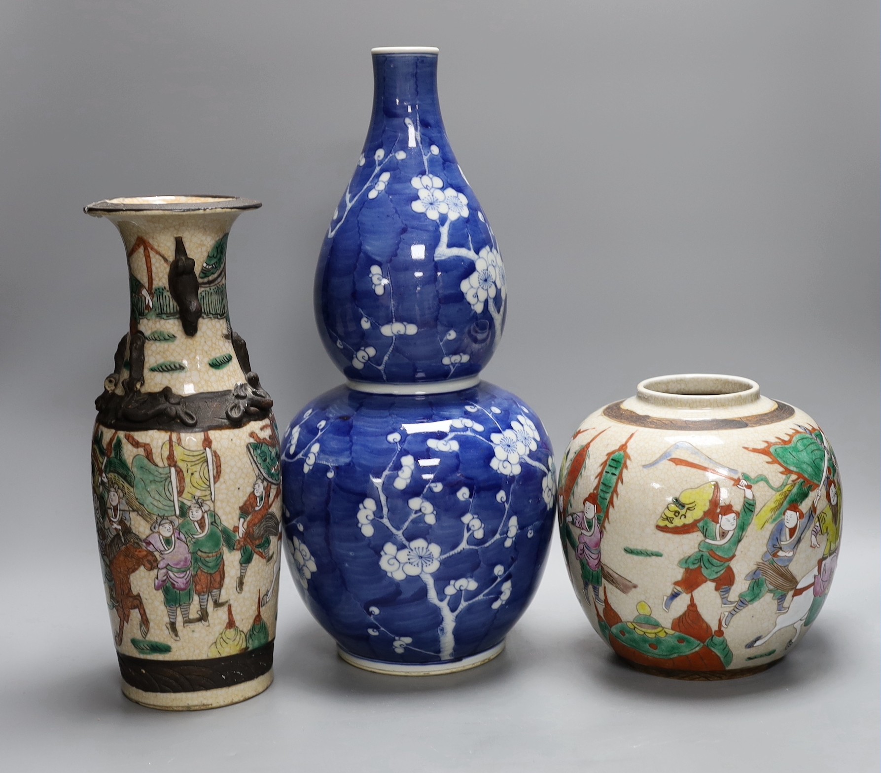 A Chinese crackle glaze vase and jar and a blue with figural decoration, together with a Chinese blue and white prunus double gourd vase, tallest 37cm